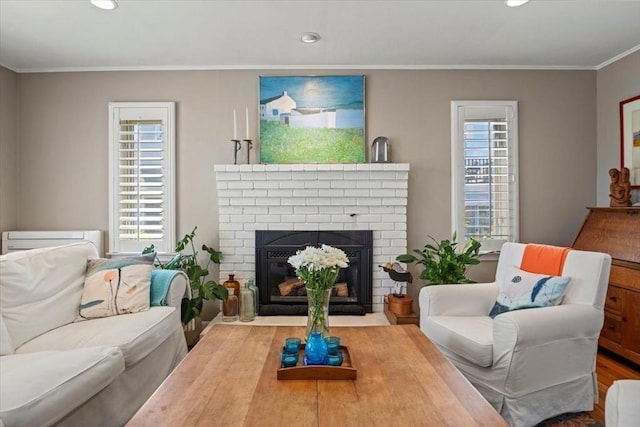 12 14th St, Newbury, MA 01951 - living room with a brick fireplace, recessed lighting, crown molding, and wood finished floors