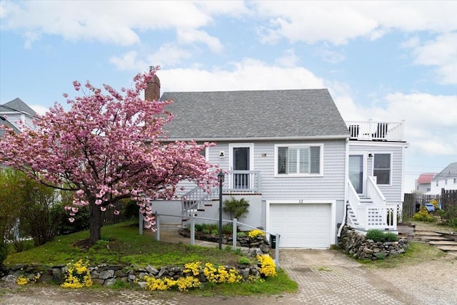 12 14th St, Newbury, MA 01951 - view of front of home featuring a shingled roof, a garage, dirt driveway, and stairway