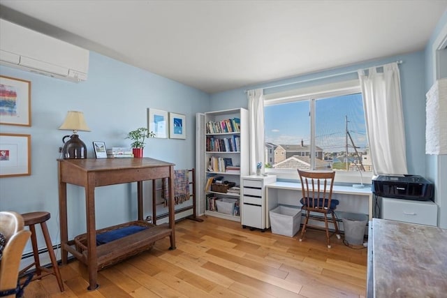 12 14th St, Newbury, MA 01951 - office area with light wood-type flooring, a wall mounted air conditioner, and baseboard heating