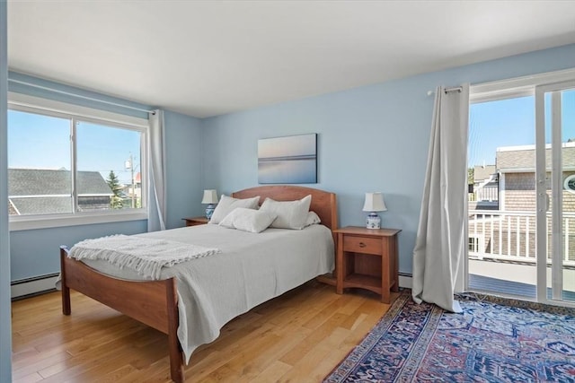 12 14th St, Newbury, MA 01951 - bedroom with baseboard heating, light wood finished floors, and access to outside