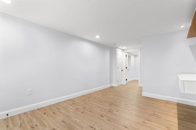 spare room featuring recessed lighting, baseboards, and light wood-style floors