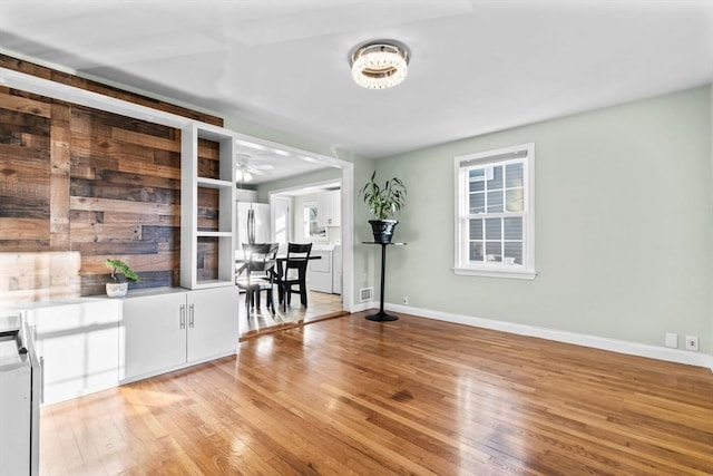 interior space featuring light wood-type flooring and baseboards