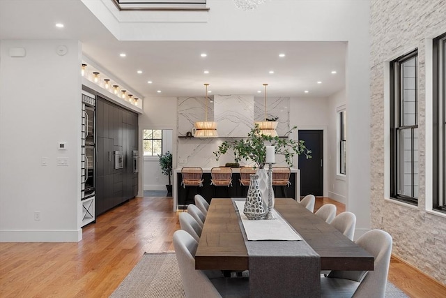 dining space with recessed lighting and light wood finished floors