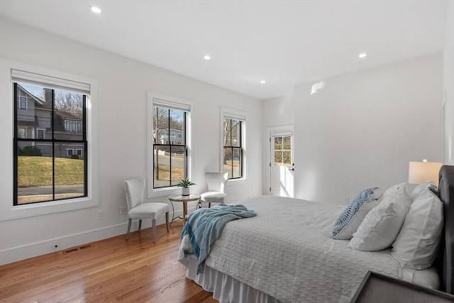 bedroom featuring visible vents, recessed lighting, baseboards, and wood finished floors