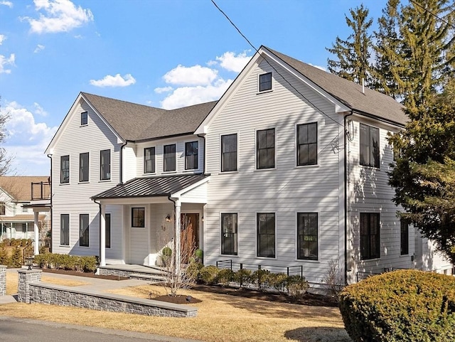 view of front of home featuring a porch, metal roof, and a standing seam roof