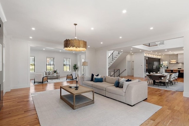 living room featuring stairs, recessed lighting, and light wood-type flooring