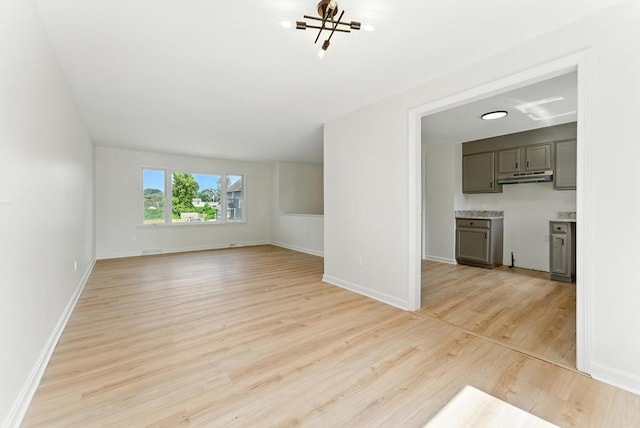 78 Saratoga Ave, Chicopee, MA 01013 - unfurnished living room featuring light wood-style flooring and a chandelier