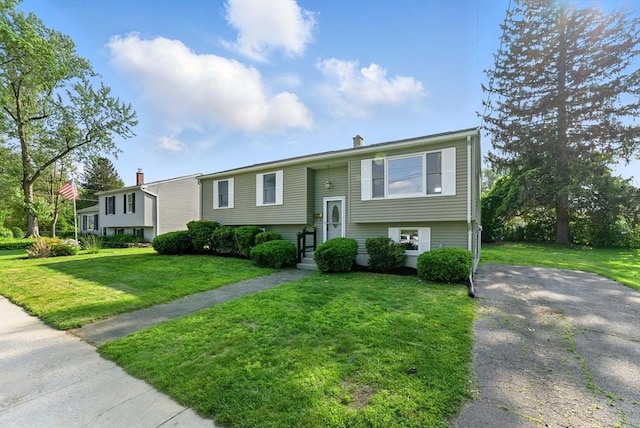 78 Saratoga Ave, Chicopee, MA 01013 - split foyer home with a front yard, driveway, and a chimney