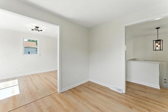 78 Saratoga Ave, Chicopee, MA 01013 - empty room with light wood-style floors and a chandelier