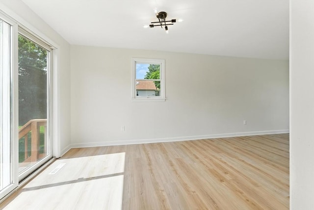 78 Saratoga Ave, Chicopee, MA 01013 - unfurnished room with healthy amount of natural light, wood finished floors, and a chandelier