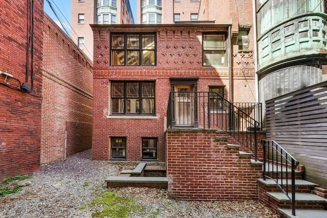 back of house featuring brick siding