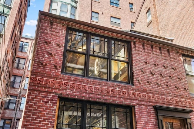 view of property exterior with brick siding