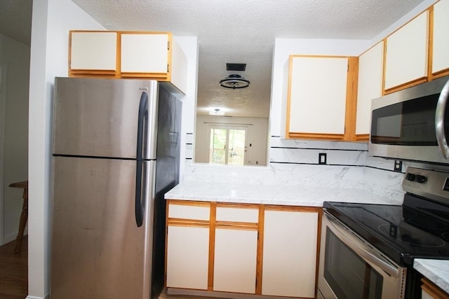 369 Aiken Ave Unit 15, Lowell, MA 01850 - kitchen with appliances with stainless steel finishes, light countertops, and a textured ceiling