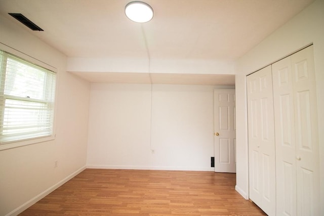 369 Aiken Ave Unit 15, Lowell, MA 01850 - unfurnished bedroom featuring light wood finished floors, a closet, and baseboards