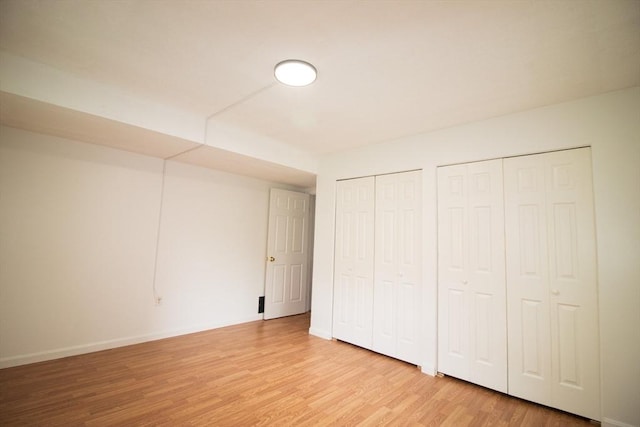 369 Aiken Ave Unit 15, Lowell, MA 01850 - unfurnished bedroom with two closets, light wood-style floors, and baseboards
