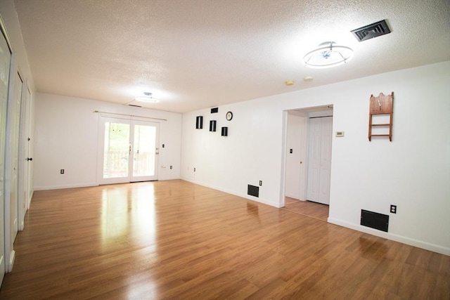 369 Aiken Ave Unit 15, Lowell, MA 01850 - spare room featuring a textured ceiling, light wood-style floors, and baseboards