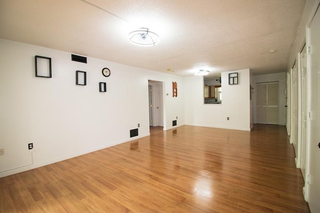 369 Aiken Ave Unit 15, Lowell, MA 01850 - spare room with light wood-style flooring, a textured ceiling, and baseboards