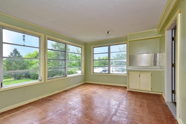 767 S Main St, Bellingham, MA 02019 - unfurnished sunroom with a textured ceiling and tile patterned floors