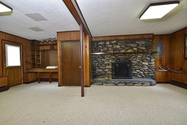 767 S Main St, Bellingham, MA 02019 - unfurnished living room with wooden walls, carpet floors, electric panel, and a fireplace