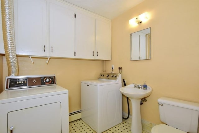 767 S Main St, Bellingham, MA 02019 - laundry room with washer and dryer, a baseboard heating unit, and light flooring