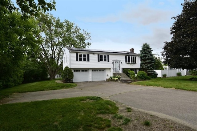 767 S Main St, Bellingham, MA 02019 - split foyer home with a chimney, an attached garage, and driveway