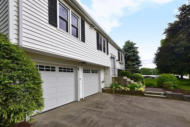 767 S Main St, Bellingham, MA 02019 - view of side of property with an attached garage and asphalt driveway