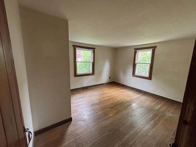 15 Reid Ave, Yarmouth, MA 02673 - empty room featuring healthy amount of natural light, wood-type flooring, and baseboards