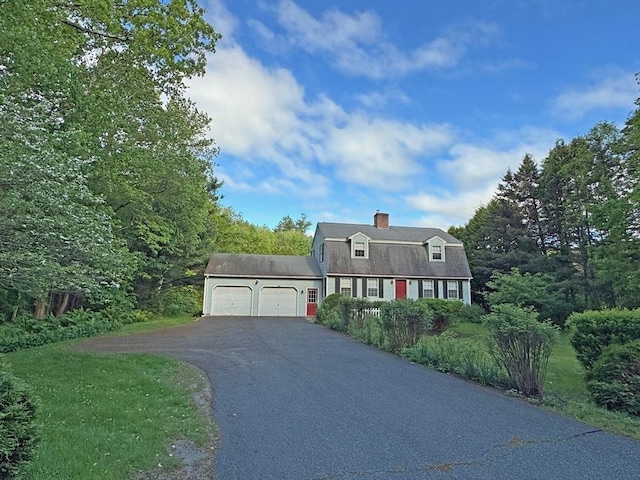 486 Turners Falls Rd, Montague, MA 01351 - dutch colonial featuring a gambrel roof, asphalt driveway, a garage, and a chimney