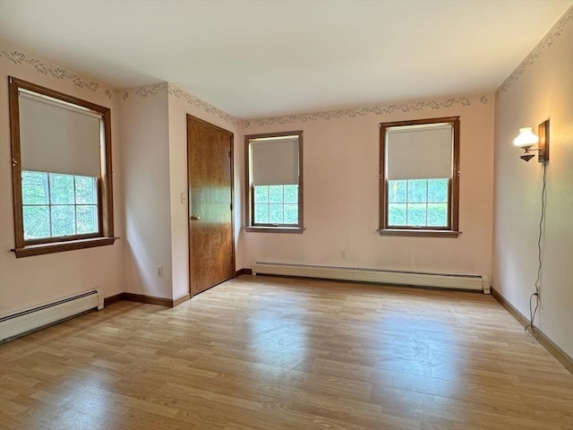 486 Turners Falls Rd, Montague, MA 01351 - empty room with a baseboard heating unit, healthy amount of natural light, and wood finished floors