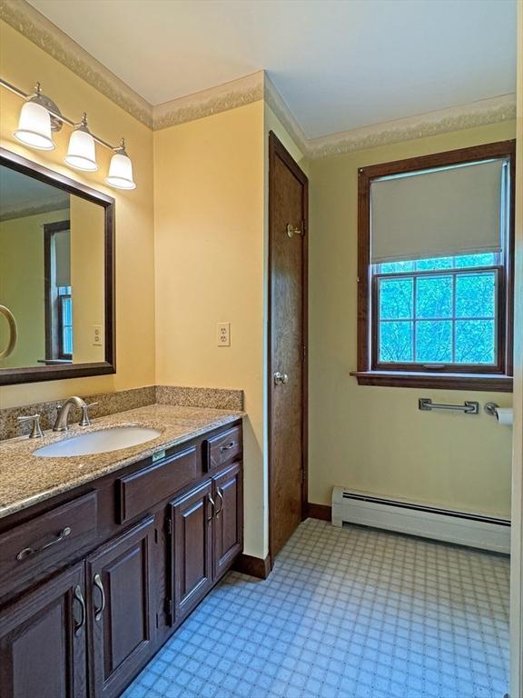 486 Turners Falls Rd, Montague, MA 01351 - bathroom featuring baseboard heating, vanity, and baseboards