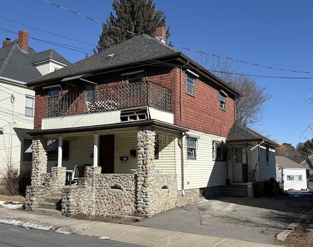 view of front of home featuring a balcony and covered porch