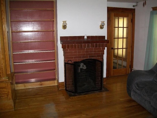 19 Chestnut, Winchendon, MA 01475 - unfurnished living room featuring wood finished floors and a brick fireplace