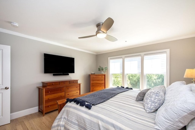 bedroom with light wood-style flooring, baseboards, ornamental molding, and a ceiling fan