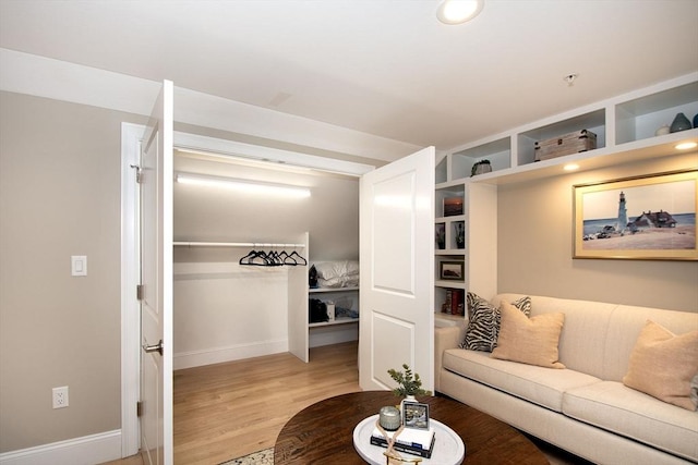 living room with baseboards and light wood-style floors