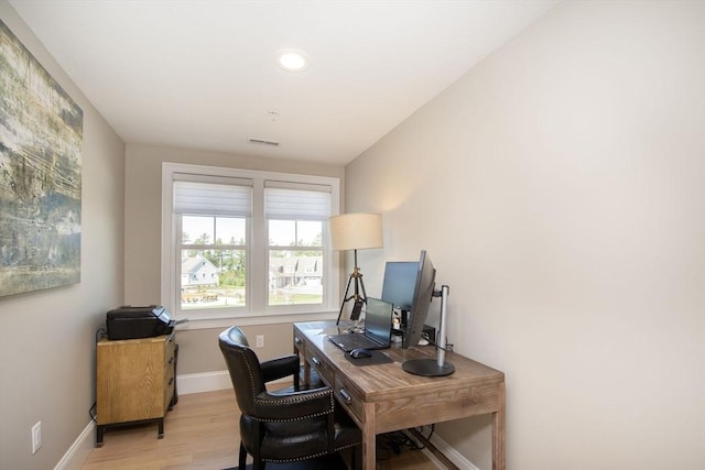 office featuring recessed lighting, light wood-style flooring, visible vents, and baseboards
