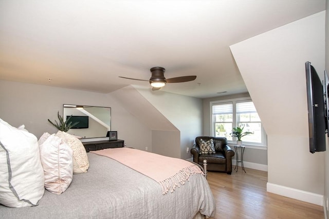 bedroom featuring ceiling fan, baseboards, and light wood-style floors