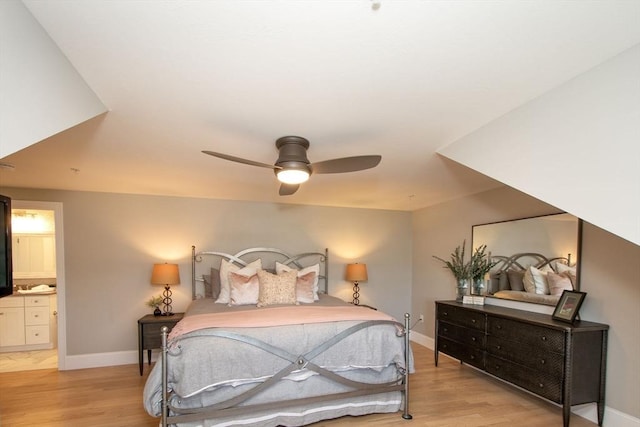 bedroom featuring light wood finished floors and baseboards