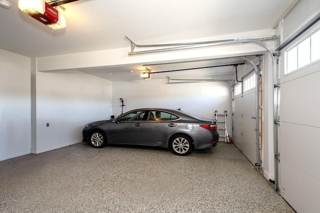 garage with baseboards and a garage door opener