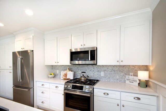 kitchen with light countertops, appliances with stainless steel finishes, and white cabinetry