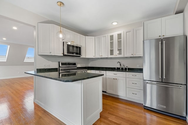 kitchen with white cabinets and appliances with stainless steel finishes