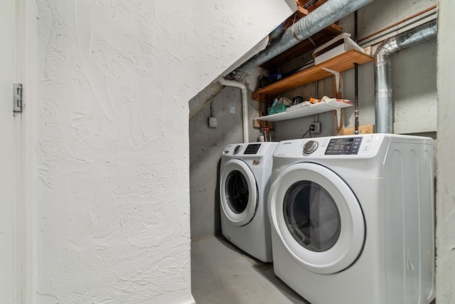 clothes washing area featuring washer and clothes dryer