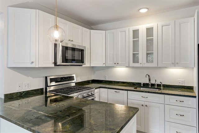 kitchen featuring white cabinets, stainless steel appliances, and sink