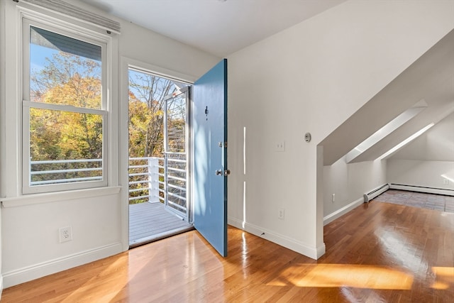 entryway with a baseboard radiator and hardwood / wood-style flooring