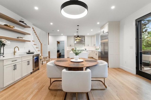 92 Cedar St, Lexington, MA 02421 - dining room with wine cooler, baseboards, light wood finished floors, stairway, and recessed lighting