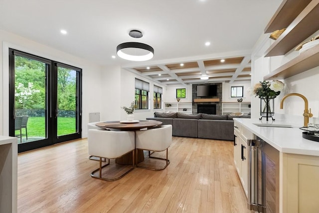92 Cedar St, Lexington, MA 02421 - dining area with coffered ceiling, light wood-style flooring, wine cooler, recessed lighting, and a large fireplace