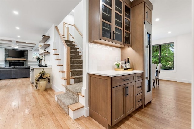 92 Cedar St, Lexington, MA 02421 - bar area featuring stairway, light wood finished floors, recessed lighting, a fireplace, and baseboards