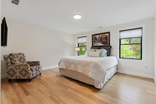 92 Cedar St, Lexington, MA 02421 - bedroom with multiple windows, light wood-style floors, and baseboards