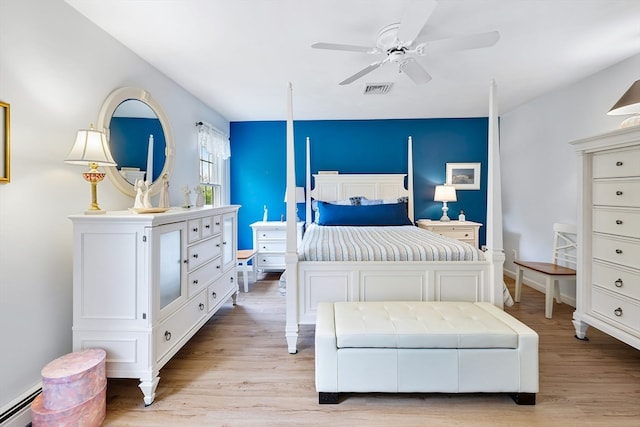 bedroom with ceiling fan, a baseboard radiator, and light hardwood / wood-style flooring