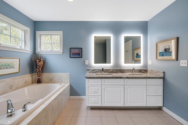 bathroom with a relaxing tiled bath, dual bowl vanity, and tile flooring