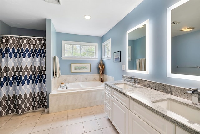 bathroom featuring tile floors, tiled bath, double sink, and oversized vanity